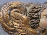 a statue of an angel with wings on it ' s head