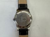 a close up of a watch on a white surface with a black strap
