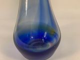 a glass vase with a blue and yellow design on it