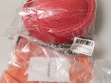 a bag of orange tape and a pair of scissors on a table