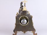 an image of a clock with a statue on top of it