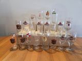 a lot of wine glasses sitting on a wooden table