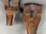 two pieces of leather are shown on a gray surface