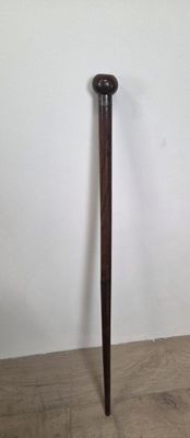 a wooden pole that is standing up against a white wall