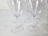 many empty wine glasses lined up on a table