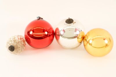 three christmas ornaments on a white surface