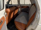 an old car with a checkered seat cover in the back of it
