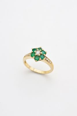 an emerald and diamond cluster ring