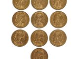 six gold sovereigns of various sizes and shapes on a white surface
