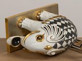 a white and gold pig shaped object on a table