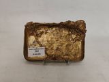 an image of a gold plate on a white surface