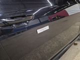 a black car with a sticker on the side of it