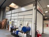 a large garage with a lot of containers and barrels