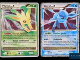 two pokemon cards that are sitting next to each other on a table