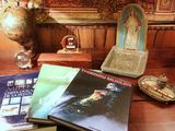 a table with books and a statue on it