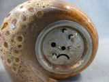 a ceramic object with a smiley face on it