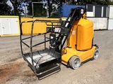 a small yellow machine that is parked in the dirt