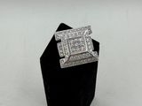 a white gold ring with a princess cut diamond set in the center