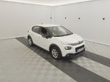 the small white car is parked in a clean room