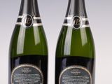 two bottles of champagne are sitting on a table