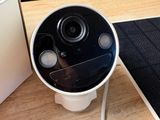 a camera that is sitting on a table next to a laptop