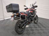 a motorcycle parked in a garage with a box on the back of it