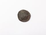 an old coin with a crown on it sitting on a white surface