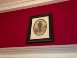a picture of a clock on the wall above a doorway
