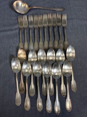 a lot of silver spoons and spoons on the table