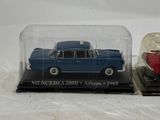a blue car in a glass case next to a red car in a glass case