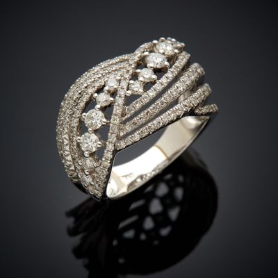 a close up of a diamond ring on a black surface