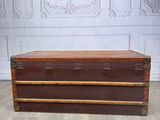 a wooden chest sitting on a hard wood floor