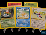 four pokemon cards are displayed on a black background