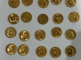 gold coins are arranged in a circle on a white surface