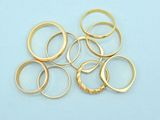 a pile of gold rings on a blue surface