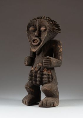 a wooden statue of a man with a mohawk on his head