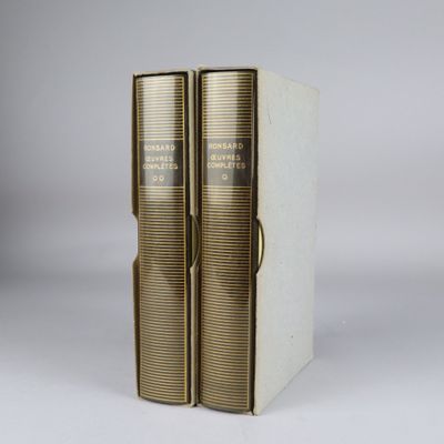 a pair of books sitting on top of each other on a table