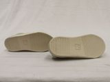 pair of white slippers on a white surface with a white background