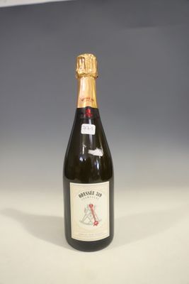 a bottle of wine sitting on top of a white table