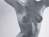 black and white photograph of a naked woman with her hands on her head