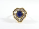 a close up of a gold ring with a blue stone in the center