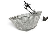 a glass bowl with a bird on top of it