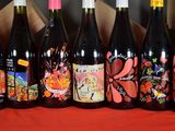 several bottles of wine are lined up in a row on a table