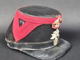 un chapeau noir orné d'un ruban rouge et d'une étoile