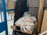 a pile of boxes and bags on a cart in a warehouse