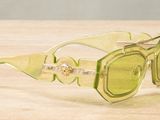 yellow sunglasses on a wooden table with a white background