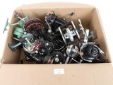 a cardboard box filled with assorted items on a white surface