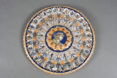 a blue and yellow plate with a face on it