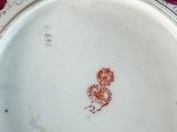 a plate with a flower design on it on a table