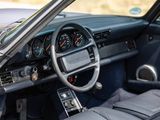 a dashboard and steering wheel of a car with a clock on it